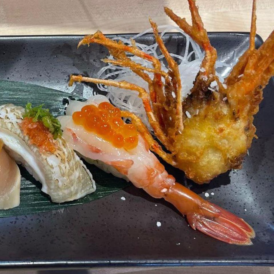 Hachi sushi & omakase: A plate of nigiri sushi with shrimp, roe, and tempura shrimp head.